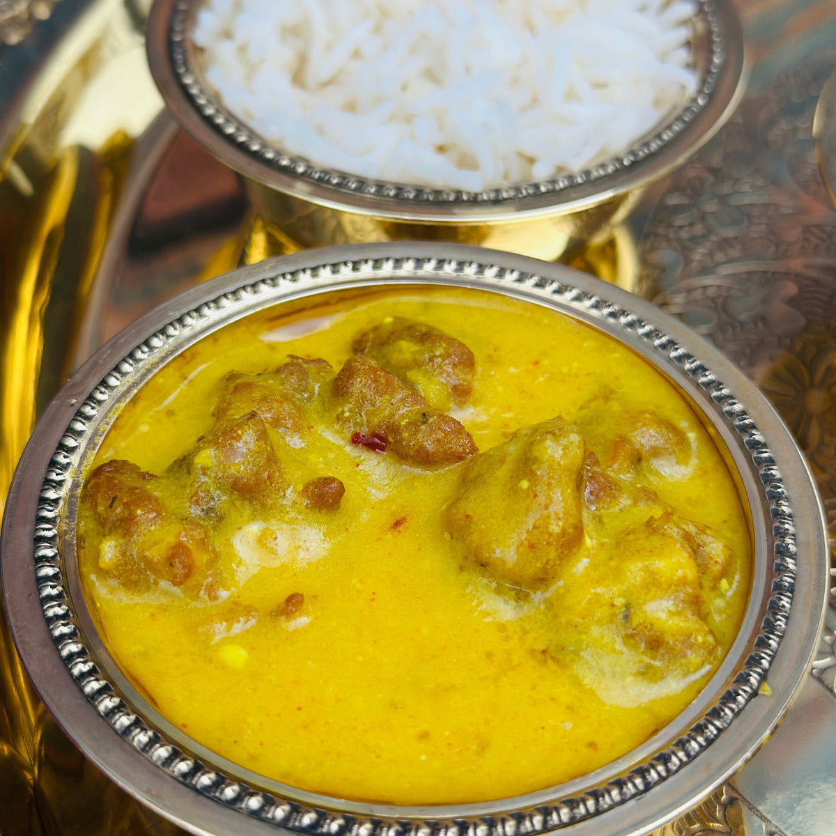 Authentic Indian catering large food tray featuring vegetarian Curry Pakora sabzi.