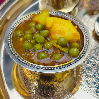Indian catering large food tray featuring authentic vegetarian sabzi curry.