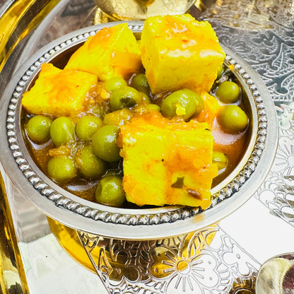Indian catering large food tray featuring traditional Matar Paneer sabzi curry.