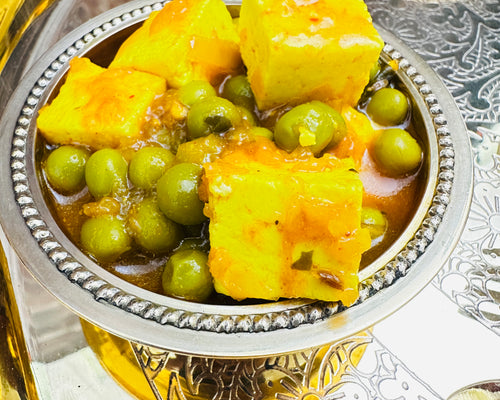 Indian catering large food tray featuring traditional Matar Paneer sabzi curry.
