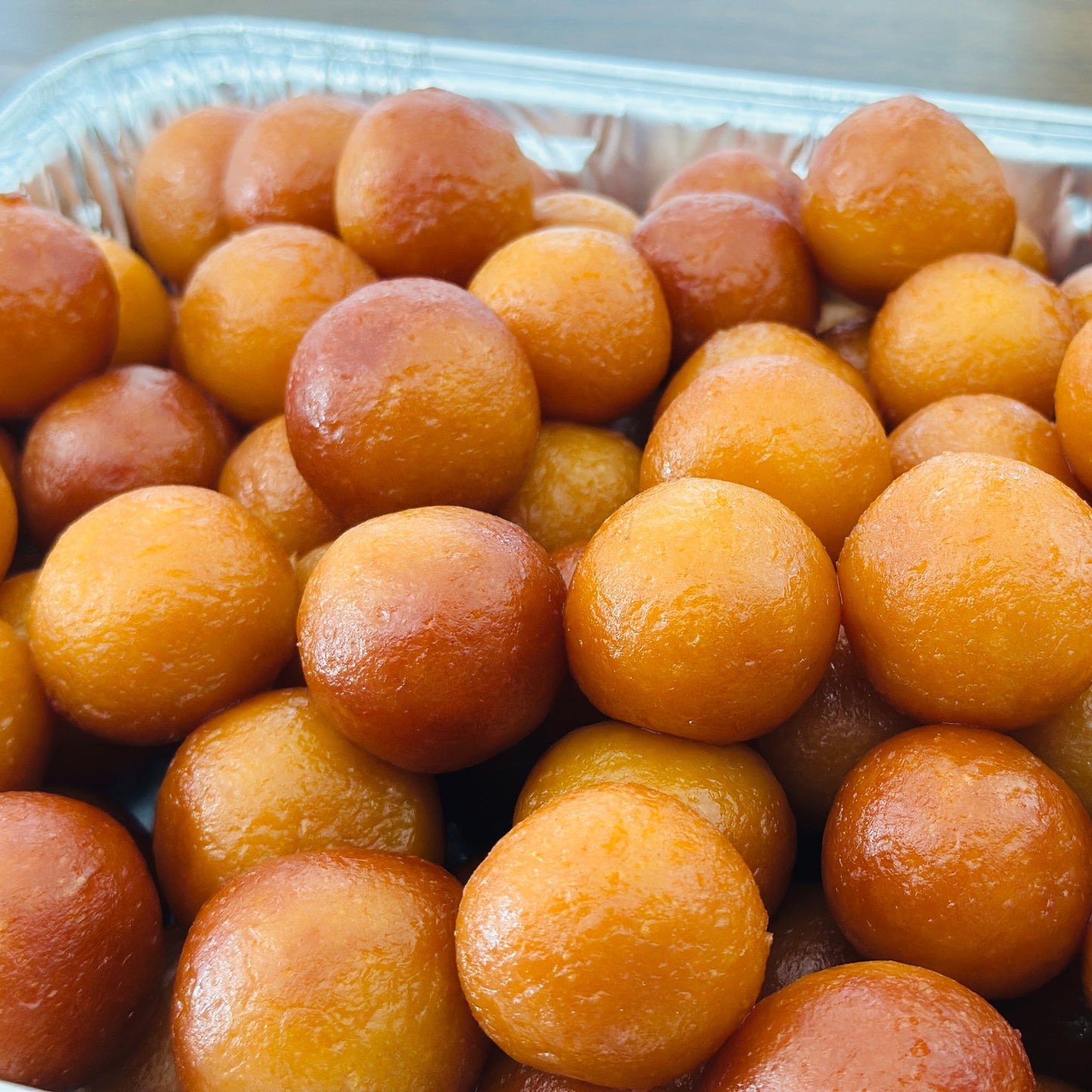 A luxurious silver platter of traditional authentic Gulab Jamuns, styled for a high-end catered event or wedding in the GTA.