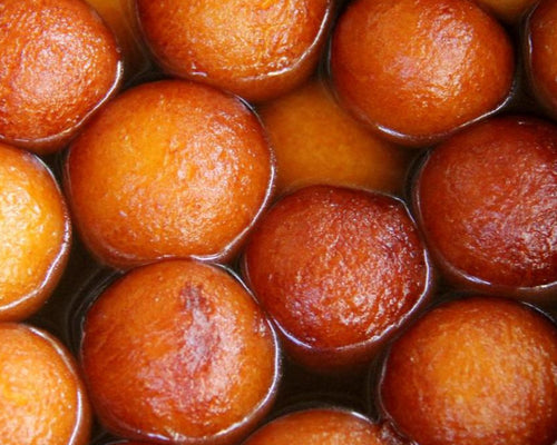 Royal Ruby Gulab Jamun – soft golden milk dumplings soaked in rose-scented sugar syrup, a beloved Indian dessert