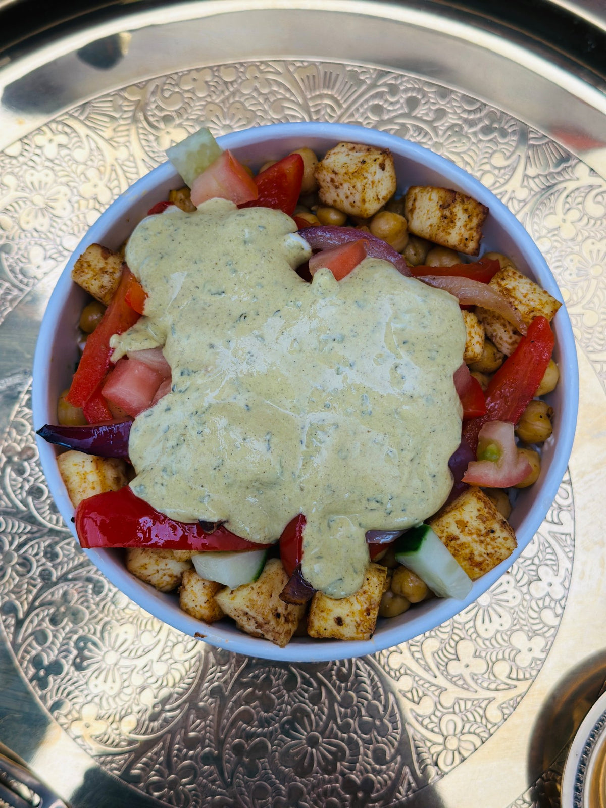 Overhead view of a Royal Ruby Protein Bowl with white chana, paneer and herb sauce